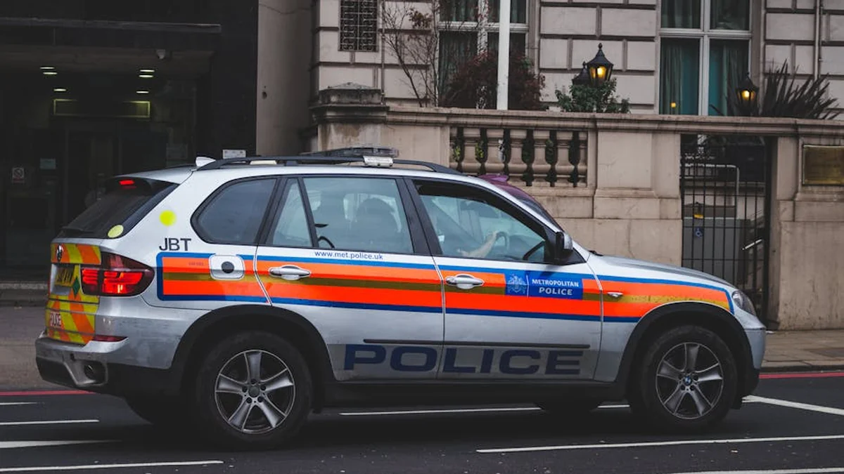 A drunk driver collided with a police vehicle, resulting in injuries to three individuals.